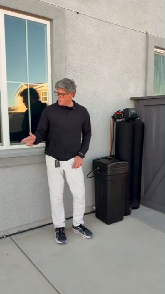 Chris beside completed whole-home filtration and softening equipment at a Folsom installation