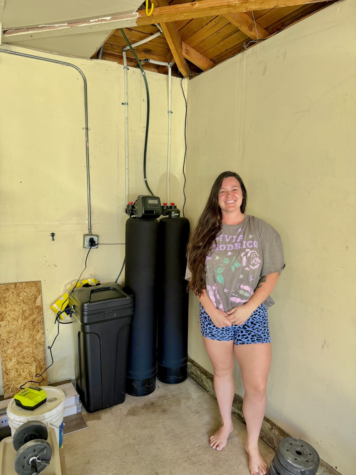Citrus Heights homeowner with Family First Water beside a completed whole-home filtration and softening installation