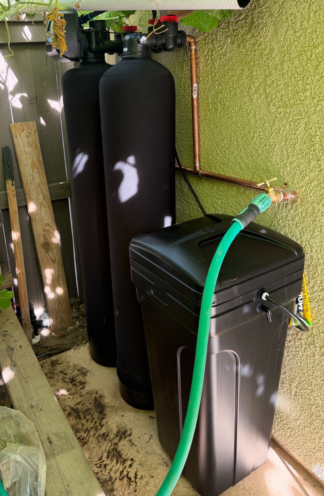 Dual-tank whole-home filtration and softening equipment installed in an outdoor utility area at a Folsom home
