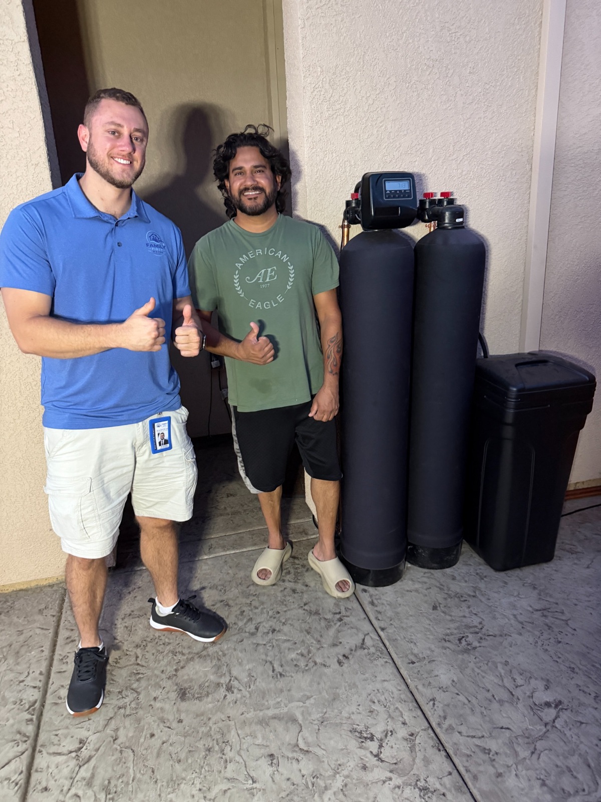 Rancho Cordova homeowner standing beside a completed whole-home filtration and softening installation